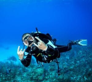 Diving into Sri Lanka's crystal-clear waters – discovering vibrant coral reefs and diverse marine life, featured in JLK Tours scuba diving and underwater adventure experiences