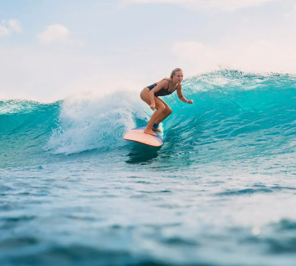 Surfing the waves along Sri Lanka’s scenic coastline – thrilling beach adventure perfect for all levels, featured in JLK Tours water sports and coastal experiences.