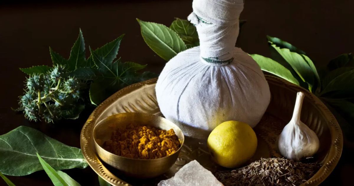 Traditional Ayurvedic medicine setup with herbs, oils, and mortar and pestle